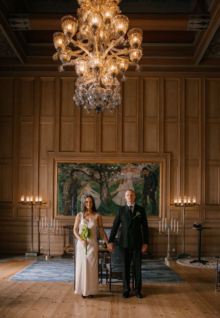 Wedding couple in a wood-panelled ballroom