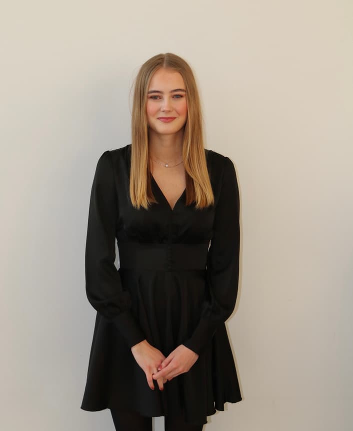 Hannah Prestegård standing in a black dress