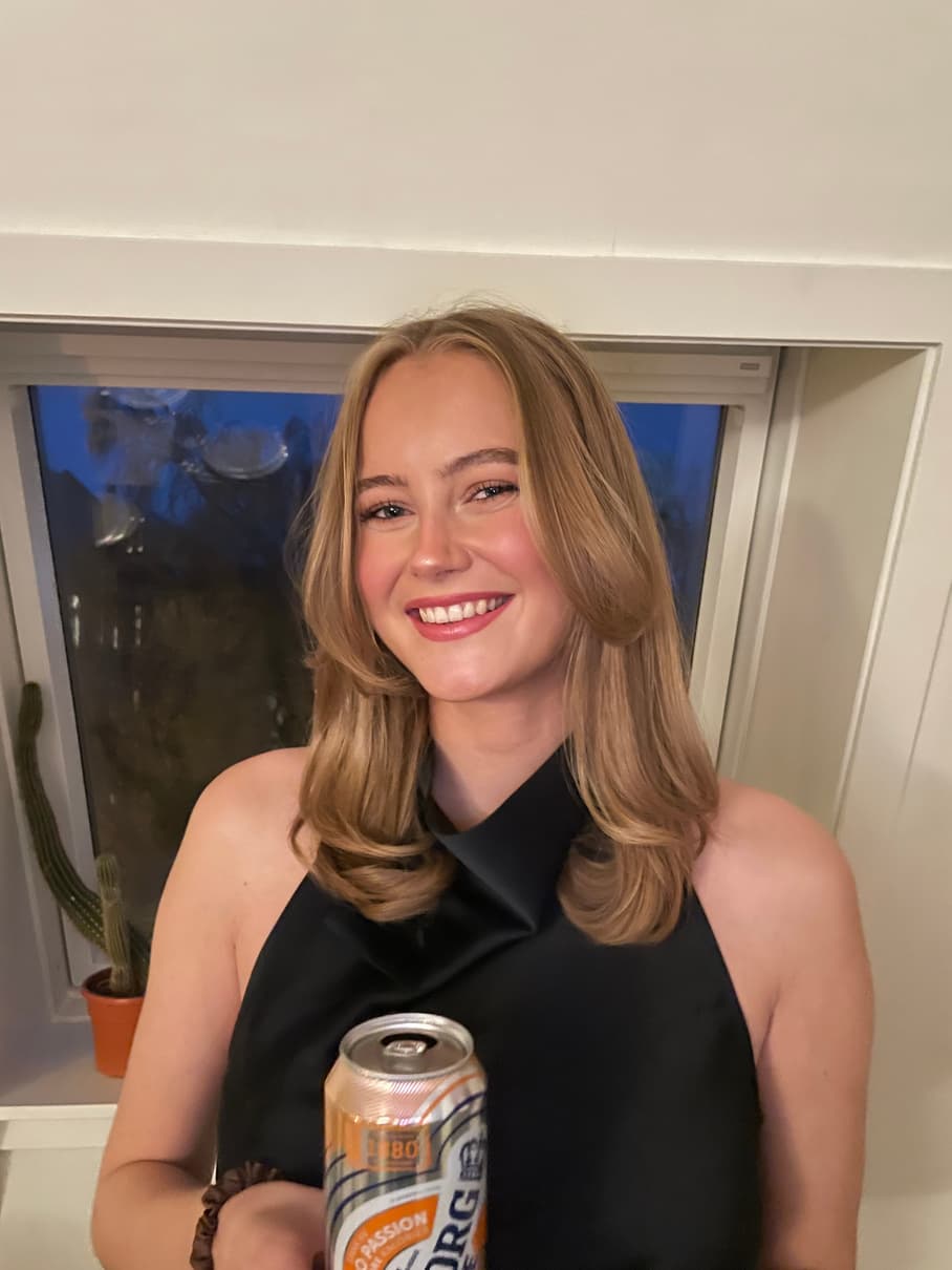 Hannah Prestegård smiling in a black halter top